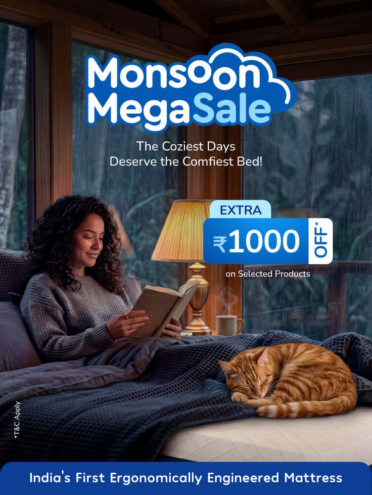 Cozy woman reading with cat by lamp in Monsoon Mega Sale for best mattress for back pain.